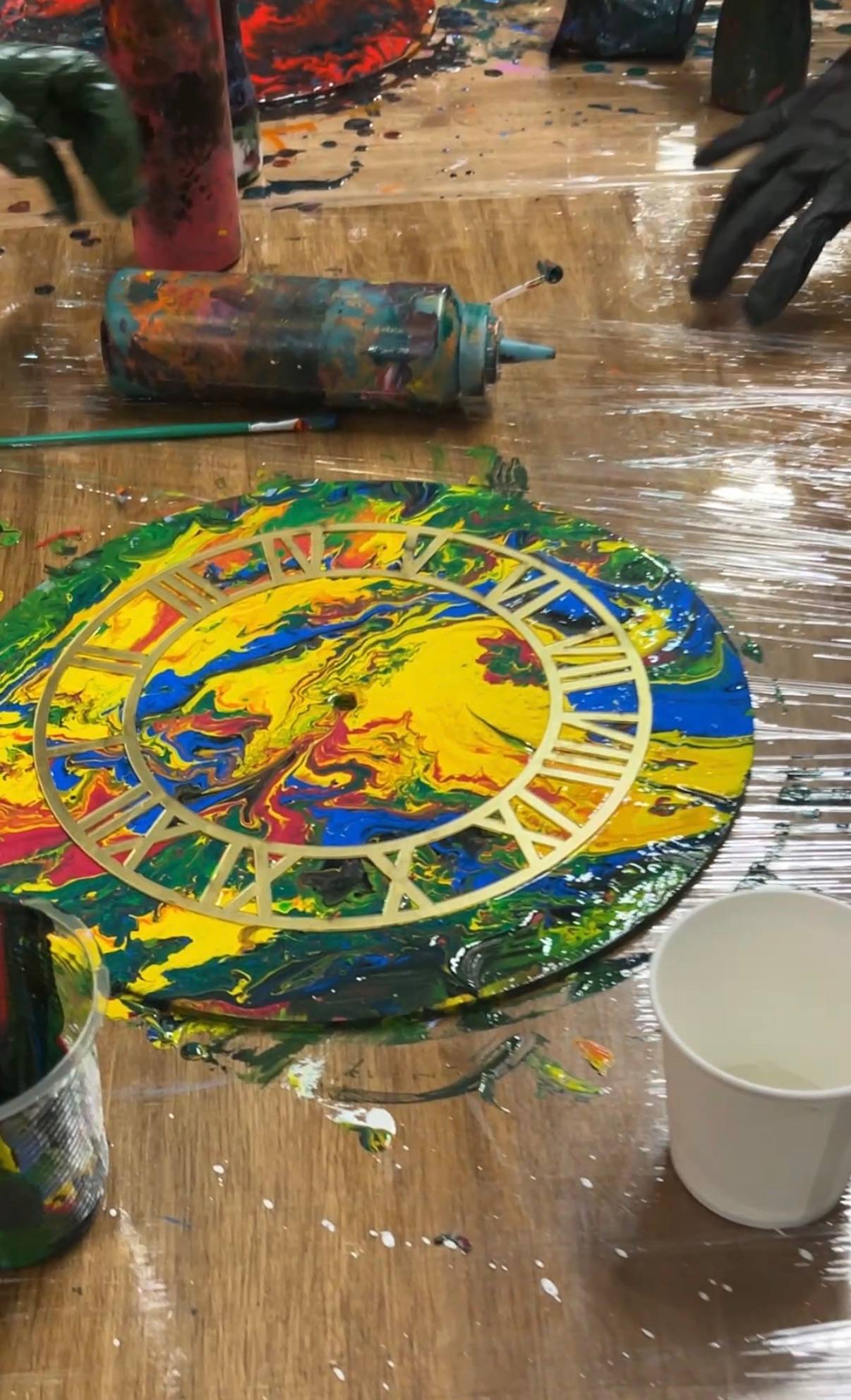 Painting a wall clock base during a Splashit workshop